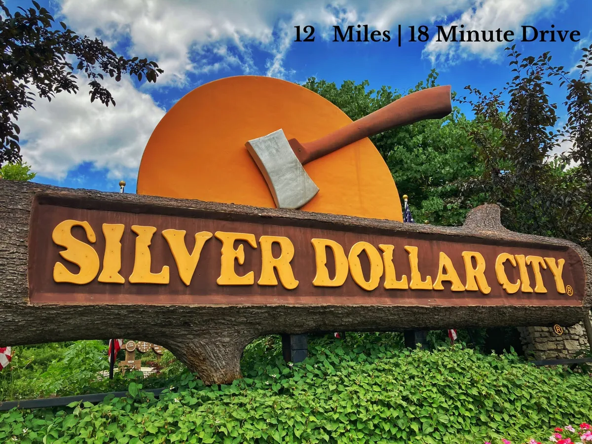 A bright, welcoming sign for Silver Dollar City, featuring bold orange hues, an axe symbol, and references to crafts and live performances. The signage evokes the festive, adventurous spirit of Branson’s premier amusement park.